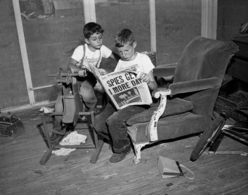 Six-year-old Robert and ten-year-old Michael read the newspaper announcing that their parents, Ethel and Julius Rosenberg, have one more day to live. New Jersey. June, 1953. Julius and Ethel Rosenberg were a  married couple who were convicted of conspiracy to commit espionage in 1951. They were put to death in the electric chair. 