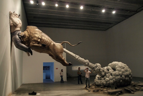 Chen Wenling’s sculpture shows a bull, meant to represent Wall Street, seen ramming the biggest con man of all time, Bernie Madoff, into a wall. The huge cloud coming out of the bull’s rear not only refers to the end of a greedy era, but also symbolizes the danger of virtual bubbles in international financial markets.