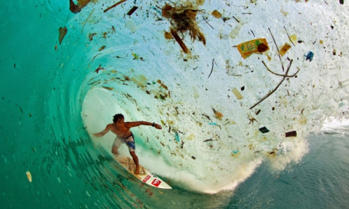 Trash WaveIndonesian surfer Dede Surinaya catches a wave in a remote but garbage-covered bay on Java, Indonesia, the world’s most populated island. Photograph: Zak NoyleSource: The Guirdian 