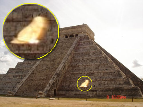 Mayan Mystery PhantomTaken by Clint Mason. He says &ldquo;I was taking pictures while my family was clapping and I caught this. This is untouched and I had about 200 pictures on this camera, and this was the only one to show this form. I also checked five other cameras that my family had. Some took pictures at or very near the same time and we were standing side by side but do not show this form." "Zoom in to this picture and you can see a figure quite clearly. It looks very similar to many of the Mayan gods drawn and carved in stone. I don&rsquo;t know what it is. I have never seen anything before or since on that camera that makes me think it is a technical "issue&rdquo; with the camera. If it is a reflection, it sure is funny; it looks like it is running on the ledge of the pyramid.&ldquo;