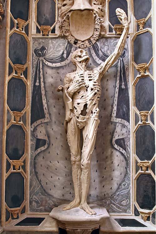 sixpenceee:Displayed in the Saint-Étienne church in France is the figure of René de Chalon, Prince of Orange. The prince died at the young age of 25 during the siege of Saint-Dizier in 1544. Rather then memorialize him in the standard hero form, his wife requested (or René himself requested, or possibly both) that he be shown as “not a standard figure but a life-size skeleton with strips of dried skin flapping over a hollow carcass, whose right hand clutches at the empty rib cage while the left hand holds high his heart in a grand gesture.” (Source)